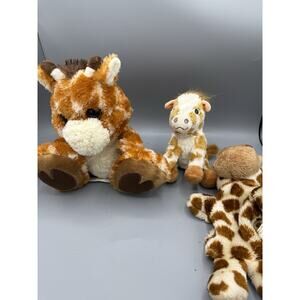 Giraffe plush lot including 3 stuffed animals in assorted sizes.